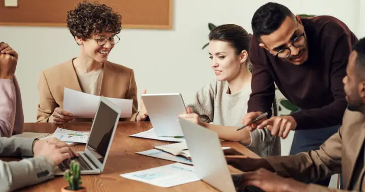 An image of people in a meeting table for the article "Applications of Strategic Human Resource Management"