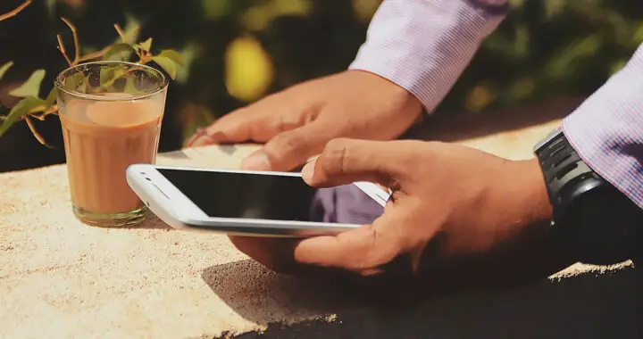 An image of two hands holding a smartphone for the article "Difference Between IPS LCD and PLS LCD"