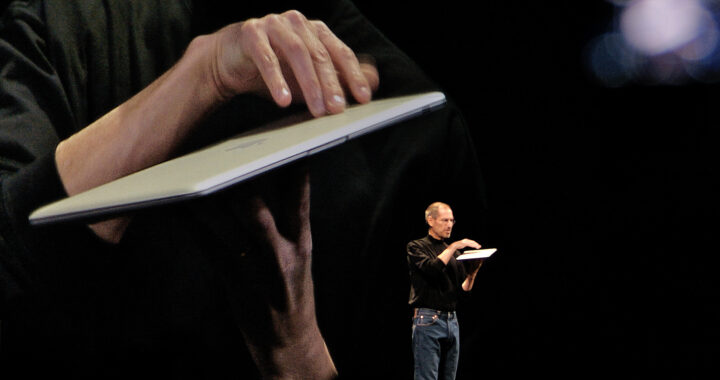 An image of Steve Jobs during one of his keynote presentations for the article "Steve Jobs: Leadership and Management Style"