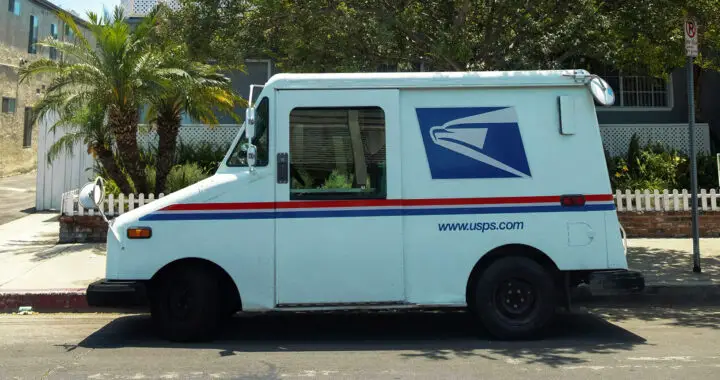 A U.S. Postal Service delivery truck parked in front of a house for the article "United States Postal Service: Importance and Challenges"