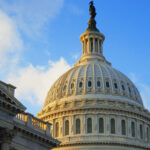 A close-up shot of the exterior dome of the U.S. Capitol for the article "Why Does Donald Trump Want To Remove The Debt Ceiling?"