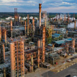 An aerial shot of an oil refinery complex in the U.S. for the article "Explainer: Why Trump Pulled Out the U.S. From the Paris Climate Agreement"