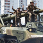 North Korean soldiers on an artillery tank for the article "Fate of North Korean Soldiers in the Russia-Ukraine War"