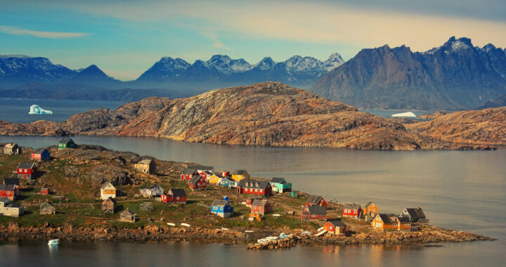 An image showing the landscape of Kulusuk municipality with some houses in Greenland for the article "Who Exactly Owns Greenland? Can It Be Readily Annexed?"